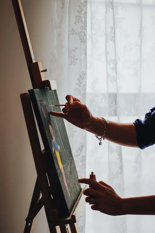 Emily K. Joynt painting at her easel